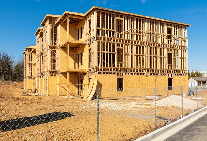 a close-up of temporary chain link fences enclosing a job site, signaling progress in the project's development in Mineral Wells